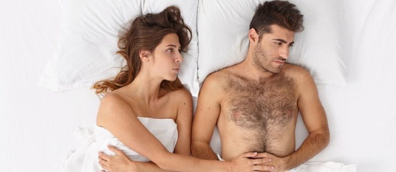 marido enojado mirando hacia otro lado y esposa tratando de convencerlo