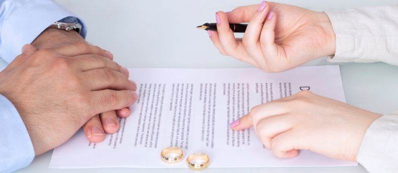 Mãos da esposa, marido assinando decreto de divórcio, dissolução, cancelamento de casamento